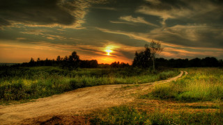 Dirt road sunset clouds landscape 2 - a dirt road in a field free wallpaper