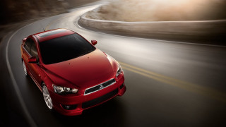 Red car driving road blurry - a red car free wallpaper