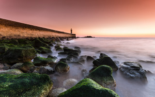 Lighthouse mossy rocks red sky - the ocean shore free wallpaper