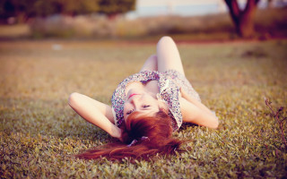 Woman grass blowing hair portrait - the grass free wallpaper