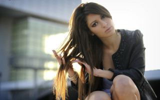 Woman blowing hair ledge building - a ledge free wallpaper