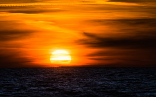 Sunset ocean boat plane beach - a sunset over the ocean free wallpaper