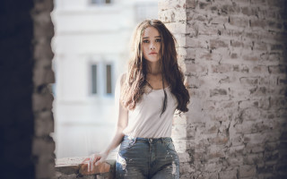 Elina karimova portrait brick wall - a woman leaning against a brick wall free wallpaper