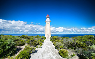 Lighthouse hill blue sky clouds - a lighthouse free wallpaper