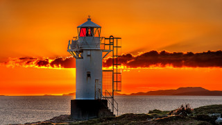 Lighthouse rocky shore sunset clouds 15 - a lighthouse free wallpaper