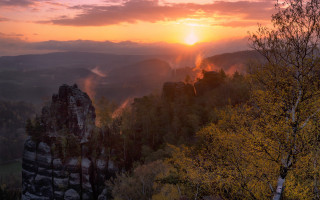 Sunset mountain forest rock formation - a sunset over a mountain free wallpaper