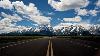 Mountain road sky clouds ocean - a mountain range in the background free wallpaper