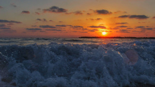 Sunset ocean waves island lighthouse - a small island in the distance free wallpaper