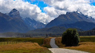 Dirt road mountains cloudy sky 2 - a cloudy sky above free wallpaper