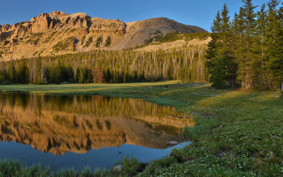 Mountain lake forest sky nature 8 - a lake in the foreground and a forest in the background free wallpaper