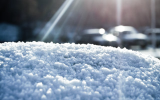 Snow covered car parked sunlight - car free wallpaper