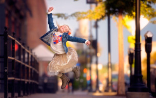 Girl jumping autumn blurry bokeh - a young girl free wallpaper