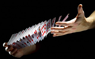 Hand stack cards black background - a hand holding free wallpaper