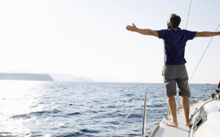 Man boat ocean outstretched arms - eric zener free wallpaper