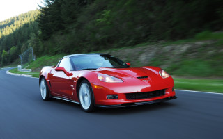 Red sports car driving forest 8 - a forest in the background free wallpaper