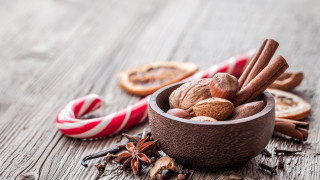 Nuts cinnamon candycanes wooden table - a wooden table free wallpaper