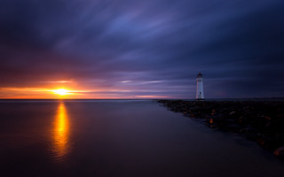 Lighthouse rocky shore sunset orange - orange light free wallpaper