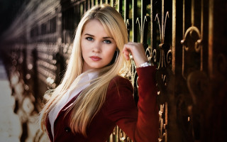Blonde woman fence serious portrait - leaning free wallpaper