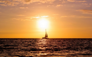 Sailboat ocean sunset clouds reflection - a sailboat free wallpaper