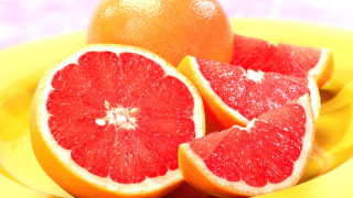 Grapefruit yellow plate blue background - half free wallpaper