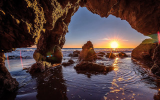 Sunset ocean cave beach rocks - a cave free wallpaper