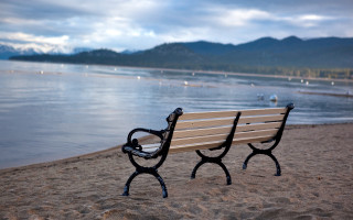 Bench beach ocean mountains sky - a sandy beach next free wallpaper