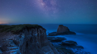 Rocky cliff water night star - sky above free wallpaper
