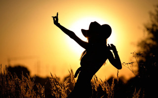 Woman cowboy hat sunset backlighting - behind her free wallpaper