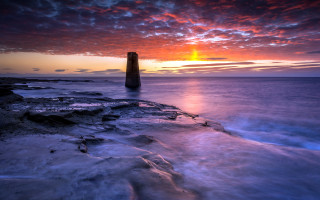 Lighthouse rocky shore sunset clouds 10 - a rocky shore free wallpaper
