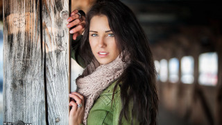 Woman holding door serious look - the door handle free wallpaper