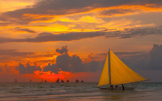 Sailboat ocean sunset cloudy sky - a sailboat free wallpaper
