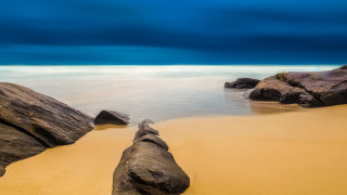 Beach rocks water cloudy sky 20 - rock and water under a cloudy sky free wallpaper