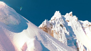 Snowboarder jumping mountain blue sky - fabien charuau free wallpaper