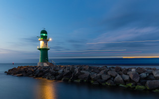 Lighthouse rocky shore night longexposure - a long exposure of light free wallpaper