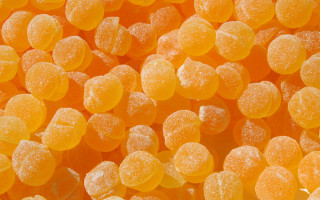 Orange candies sugar white background 2 - a yellow flower free wallpaper