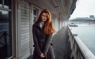 Red haired woman porch water - a bridge in the background free wallpaper