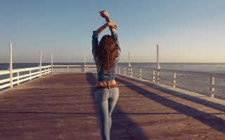 Woman pier cellphone arms up - a cell free wallpaper