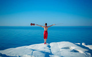 Woman standing on rock arms - surreal free wallpaper