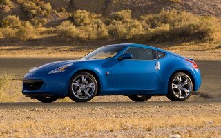 Blue sports car desert road 3 - a dry grass field free wallpaper