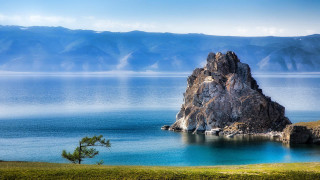 Large rock island mountain shore - the water near a mountain range free wallpaper