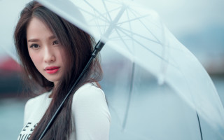 Woman smiling umbrella outdoors rain - an umbrella in front free wallpaper