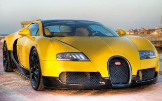 Yellow bugatti brick road pier - a boat in the background free wallpaper