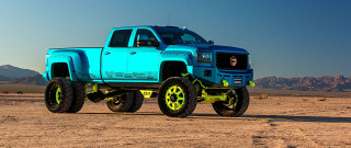 Blue truck yellow wheels desert - vibrant color scheme free wallpaper