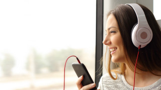 Woman headphones smiling train cellphone - her cell phone free wallpaper