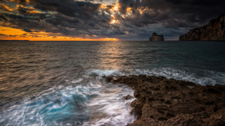 Rocky cliff sunset water clouds - a rocky cliff free wallpaper