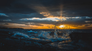 Sunset water splash rocks clouds - stormy weather free wallpaper