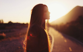Woman sunset backlighting blowinghair profile - the sun setting behind her free wallpaper