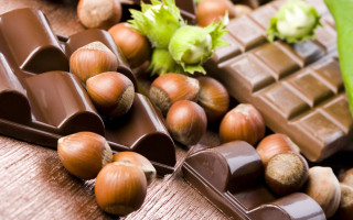 Chocolates nuts wooden table green - chocolate free wallpaper