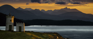 Lighthouse hill overlooking water mountains - dugald sutherland maccoll free wallpaper
