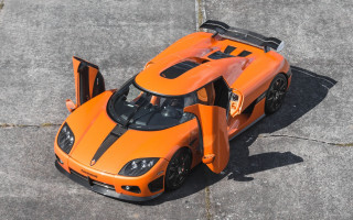 Orange sports car open hood - a concrete surface free wallpaper